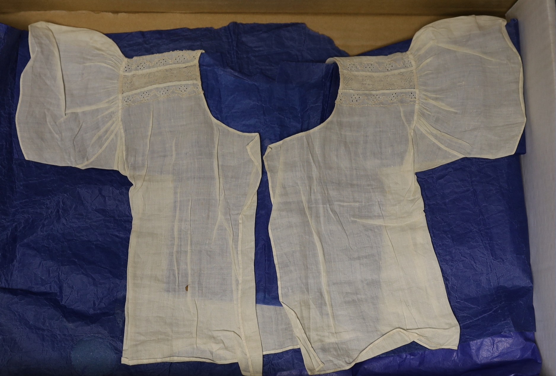 An 18th century, rare fine linen, Broiderie Anglaise andHollie point lace worked baby’s vest. The two Hollie point insertions read: FEAR GOD AND KEEP HIS LAWS. Dated : MAY 3 1768.